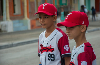 two young boys in baseball uniforms