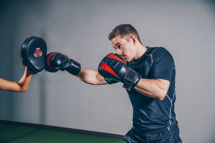 boxer or MMA man training on a heavy punching bag