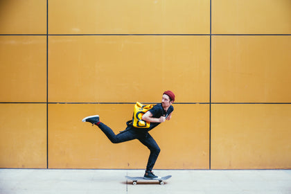 young man skateboarding in on a sidewalk